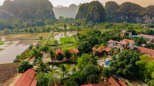 an aerial view of a resort with a river and mountains at Tam Coc Green Garden Bungalow in Ninh Binh