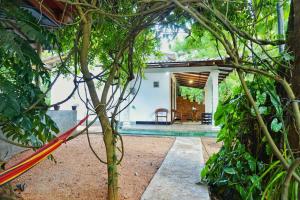 a view of a house through the trees at Sunrise Villa Pidurangala in Sigiriya