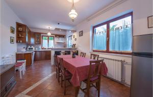 a kitchen and dining room with a table and chairs at Holiday Home Krse Cr in Premantura