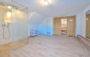 an empty room with a glass shower in a house at Cozy Home In Unesic With Sauna in Unešić