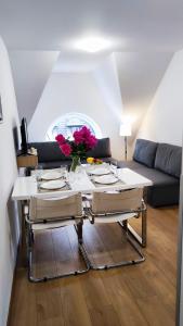 a living room with a table and a couch at Apartamenty INTERDOM in Zakopane