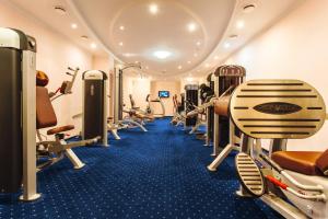a gym with lots of treadmills and machines at Rasstal Spa Hotel in Naberezhnyye Chelny