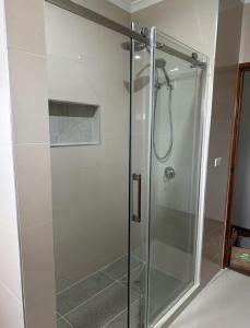 a shower with a glass door in a bathroom at Guest Room in Kealba in St Albans