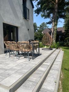 a table and chairs sitting on a patio at Rozewie Apart in Jastrzębia Góra