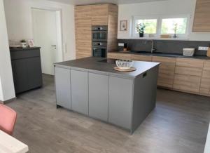 a kitchen with a large island in the middle at Ferienwohnung König in Schnaittenbach