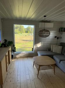a living room with a couch and a table at Boende på Marholmen in Norrtälje