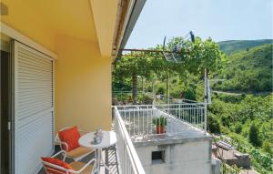 a balcony with a table and chairs and a view at 2 Bedroom Amazing Apartment In Slime in Slime +15 photos