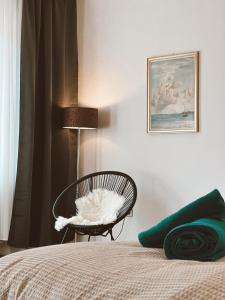 a bedroom with a chair next to a bed at LEON Sleep&Stay in Kassel