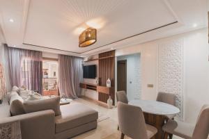 a living room with a couch and a table at Luxury Guéliz Apart 2 bedrooms in Marrakech +1 photo