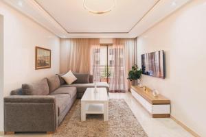 a living room with a couch and a table at Luxury Guéliz Apart 2 bedrooms in Marrakech