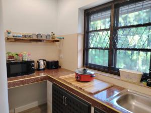 a kitchen with a counter top with a pot on a cutting board at The Well House By Dao in Ban Doi Hang