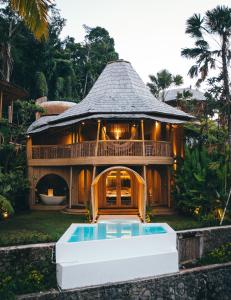 a house with a pool in front of it at Eco Six Bali in Tampaksiring