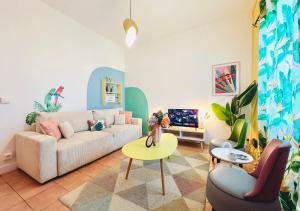 a living room with a couch and a table at Le Mambo in Noumea