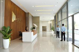 a group of people standing in a lobby at Masteri Thao Dien Riverside Apartment in Ho Chi Minh City