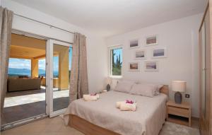 a bedroom with a bed with two pillows on it at Stunning Home In Zrnovo With Wifi in Korčula +59 photos