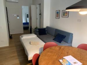 a living room with a bed and a table and chairs at Zeus at Como Duomo - Luxury Collection in Como