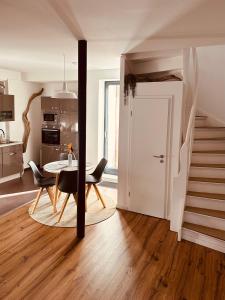 a kitchen and dining room with a table and chairs at Lieblingsbude Schwerin in Schwerin +14 photos