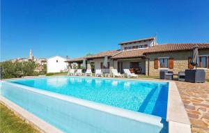 a swimming pool in front of a house at Villa Ciano in Višnjan