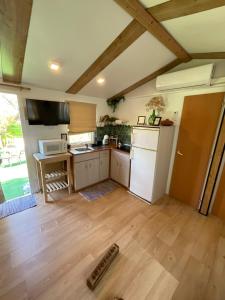 a kitchen with a white refrigerator and a counter at Nómada, Casa Cerca de Sevilla in Alcalá de Guadaira