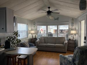 a living room with a couch and a ceiling fan at Seaside Therapy in Myrtle Beach