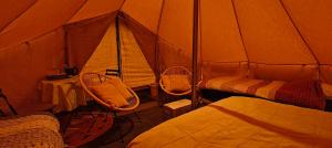 a room with two beds and a tent at Au Pied Du Trieu, the glamping experience in Labroye