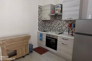 a small kitchen with a refrigerator and a counter at Villa Eufemia in Pedara