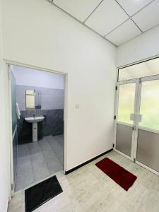 a bathroom with a toilet and a sink and a glass door at Water Bird's Resort & Yala Safari in Tissamaharama