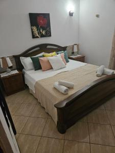 a bedroom with a large bed with pillows at Restauraunt-Kalaja in (( Bokaj ))