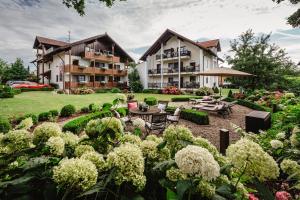 a resort with a garden and a building at Appartementhaus Silvia in Bad Füssing
