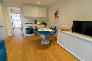 a kitchen with a table with chairs and a television at Attico 58 in Foggia