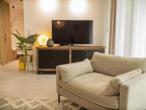 a living room with a couch and a flat screen tv at MyFreedom Panorama Cubana Apartment in Alsóörs