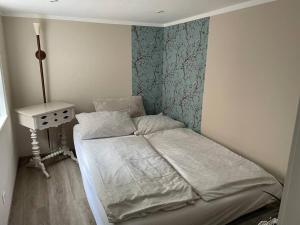 a small bedroom with a bed and a table at Ferienhaus Charlotte in Goslar