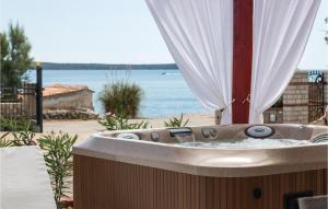 a bath tub with a view of the ocean at Stunning Home In Nerezine in Nerezine