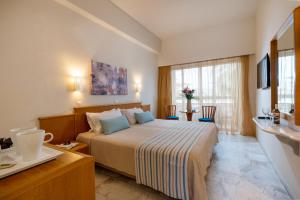 Posteľ alebo postele v izbe v ubytovaní Minos Hotel