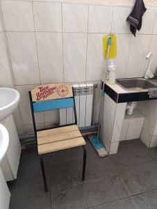 a wooden chair in a bathroom with a sink at Хостел Sweet Home in Mykolaiv +16 photos