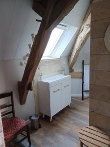 a kitchen with a sink and a skylight at numéro 2 le gîte in Civray-sur-Esves