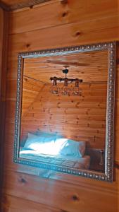 a mirror hanging above a bed in a room at Villa Davisol in Theth +59 photos