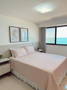 a bedroom with a large bed and a window at Praia da Costa, SUNRISE STAY in Vila Velha +22 photos