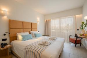 Posteľ alebo postele v izbe v ubytovaní Minos Hotel
