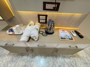 a table with towels and a book on it at The Marigold Bliss in Agra