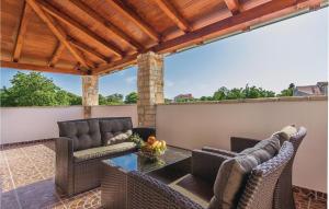 an outdoor patio with two chairs and a table at Holiday Home Svetvincenat With Outdoor Swimming Pool 207 in Svetvinčenat