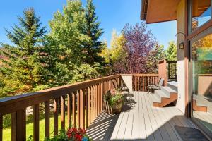 a deck with benches and flowers on a house at Ridge 27 in Snowmass Village