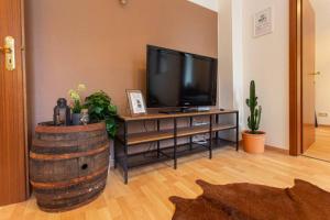 a living room with a television and a barrel at Pretty Home Wild West Zentrum in Chemnitz +10 photos