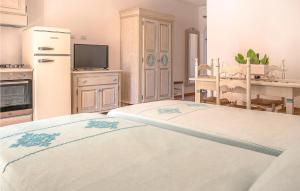 a kitchen with a bed and a refrigerator at Bilo 5 in Orosei