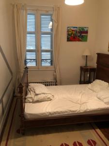 トゥルヴィル・シュル・メールにあるMaison 5 chambres, jardinet, accès plageのベッドと窓のある寝室