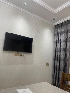 a flat screen tv hanging on a wall at Baku, 4th microdistrict close to the Ecemi metro station, 20 January street AZ1010 in Baku