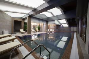 a large swimming pool in a building with a ceiling at Amira Boutique Hotel in Bansko