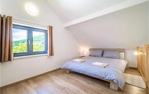 a bedroom with a bed and a window at 4 Bedroom Nice Home In Ivancici in Ivančići