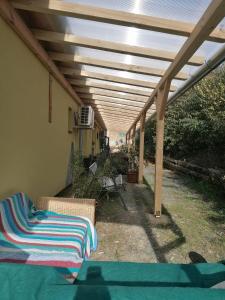 a patio with awning and a couch under a roof at Berkenyés Vendégház in Zalalövő