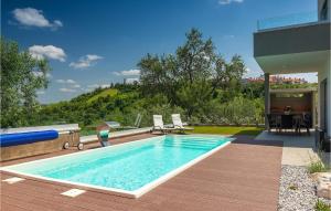 a swimming pool on a deck next to a house at Villa Primavera in Buje